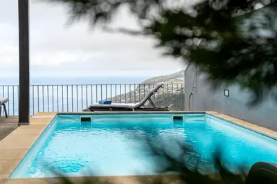 a swimming pool with a view of the ocean at Villa Antonina by Madeira Real in Arco da Calheta
