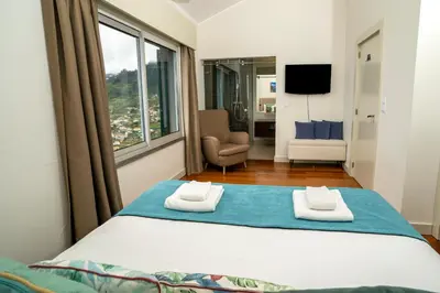 a bedroom with a large bed with a window at Villa Antonina by Madeira Real in Arco da Calheta