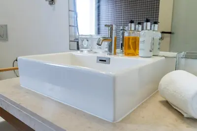a white sink with bottles on top of a counter at Villa Antonina by Madeira Real in Arco da Calheta