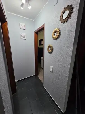 a hallway with two mirrors on the wall and a mirror at Apartment Matur View in Machico