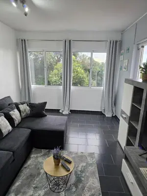 a living room with a couch and a table at Apartment Matur View in Machico