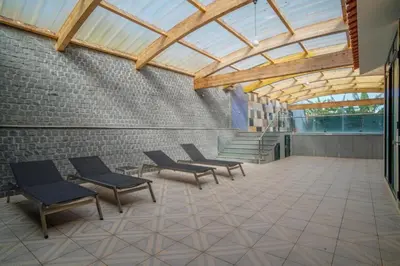 a building with four chairs and a glass ceiling at Casa Giri in Relógio do Poiso