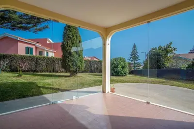 a view of a house through the glass of a patio at Casa Giri in Relógio do Poiso
