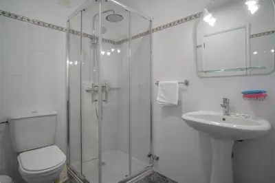 a bathroom with a shower and a toilet and a sink at Casa Giri in Relógio do Poiso