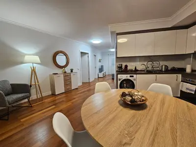 a kitchen and dining room with a table and chairs at Santa Cruz Center by Rentallido in Santa Cruz