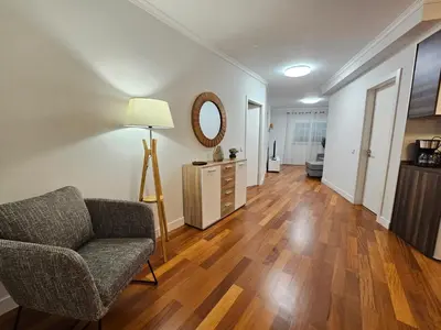 a living room with a chair and a mirror at Santa Cruz Center by Rentallido in Santa Cruz