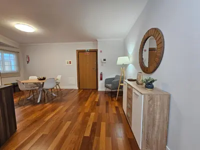 a living room with a table and a mirror at Santa Cruz Center by Rentallido in Santa Cruz