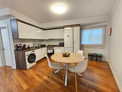 a kitchen and dining room with a table and chairs at Santa Cruz Center by Rentallido in Santa Cruz
