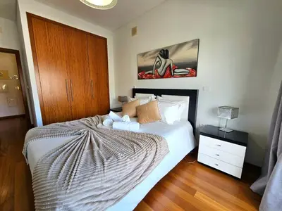 a bedroom with a bed and a wooden floor at Concórdia Apartment by Rentallido in Funchal