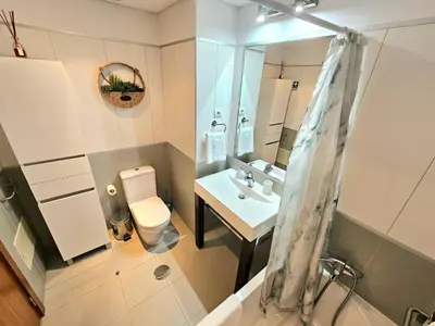 a bathroom with a toilet and a sink and a mirror at Concórdia Apartment by Rentallido in Funchal