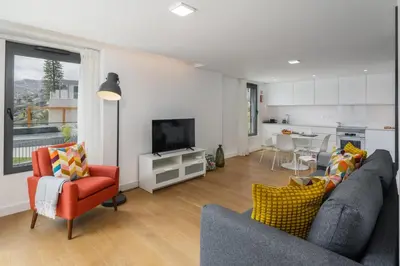 a living room with a couch and chairs and a television at Acqua Residence VIII by An Island Apart in Funchal
