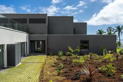 a modern house with a garden in front of it at Acqua Residence VIII by An Island Apart in Funchal