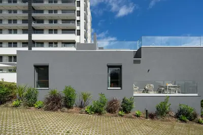 a gray house with plants in front of a building at Acqua Residence VIII by An Island Apart in Funchal