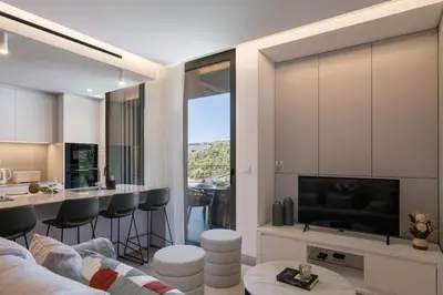 a living room with a couch and a tv at Calheta Hills I by An Island Apart in Calheta