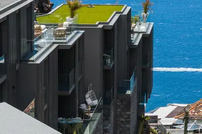 an aerial view of a building with the ocean in the background at Calheta Hills I by An Island Apart in Calheta