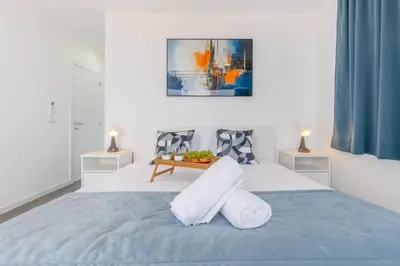 a bedroom with a bed with towels on it at Villa Oceano Sereno by GALMI in Ponta do Sol