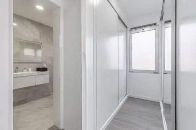 a white bathroom with a shower and a sink at Villa Oceano Sereno by GALMI in Ponta do Sol