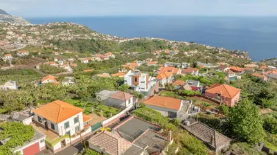 an aerial view of a village with houses and the ocean at Villa Oceano Sereno by GALMI in Ponta do Sol