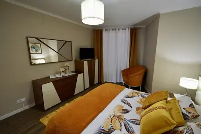 a bedroom with a bed and a desk and a television at Madalena Sunset by Mill Escapes in Madalena do Mar