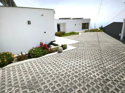 a balcony with a view of a hill with a tree at CASA PANORAMA SOL- NEW VILLA WITH HEATED SALTWATER POOL and FANTASTIC SEA VIEW in Ponta do Sol