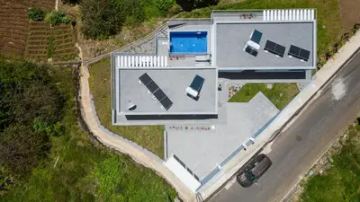 an overhead view of a house with a car at CASA PANORAMA SOL- NEW VILLA WITH HEATED SALTWATER POOL and FANTASTIC SEA VIEW in Ponta do Sol