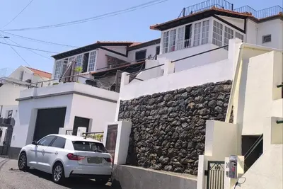a white car parked in front of a building at Consolação Sea View in Funchal