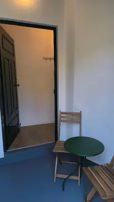 a room with a table and a chair and a door at Consolação Sea View in Funchal