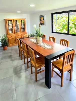 a dining room with a wooden table and chairs at Annamoraj by Eurostay - Nature's peace - Your cozy escape! in Ribeira Brava