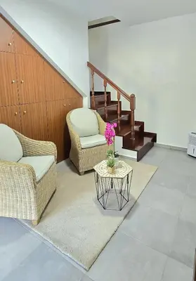 a living room with two chairs and a table at Annamoraj by Eurostay - Nature's peace - Your cozy escape! in Ribeira Brava