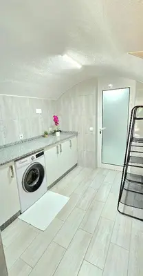 a white laundry room with a washing machine in it at Annamoraj by Eurostay - Nature's peace - Your cozy escape! in Ribeira Brava