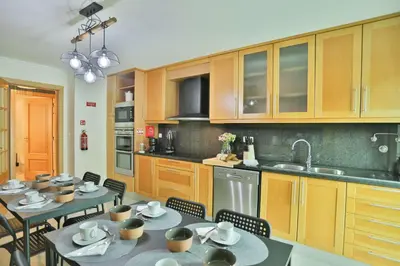 a kitchen with tables and chairs in a kitchen at The Panoramic View Suites in Machico