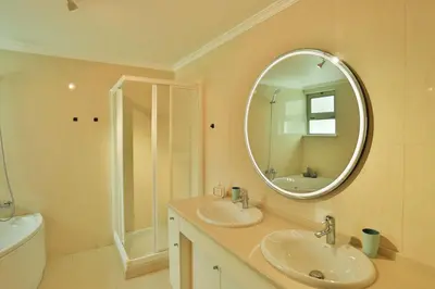 a bathroom with two sinks and a mirror at The Panoramic View Suites in Machico