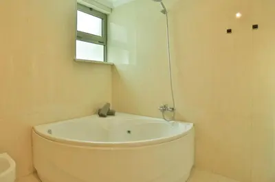 a white bath tub in a bathroom with a window at The Panoramic View Suites in Machico