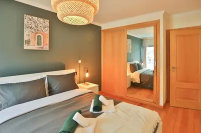 a bedroom with a bed and a large mirror at The Panoramic View Suites in Machico