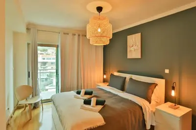 a bedroom with a large bed and a window at The Panoramic View Suites in Machico