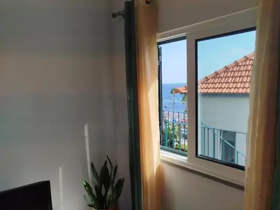 a balcony with a view of a building at Baía dos Lobos in Câmara de Lobos