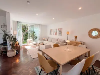 a living room with a table and a couch at Sunny Double Room in 4BR Villa with AC, Sea View Balcony, Workspace in Funchal