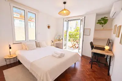 a bedroom with a bed and a desk and a table at Sunny Double Room in 4BR Villa with AC, Sea View Balcony, Workspace in Funchal