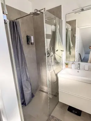 a bathroom with a shower and a sink at Sunny Double Room in 4BR Villa with AC, Sea View Balcony, Workspace in Funchal