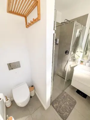 a bathroom with a shower and a toilet at Sunny Double Room in 4BR Villa with AC, Sea View Balcony, Workspace in Funchal