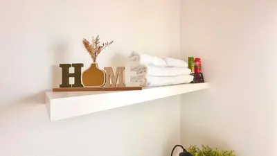 a shelf with towels on a white wall at Edna 2 in Funchal