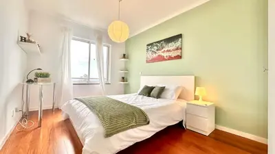a bedroom with a bed with white sheets and a window at Edna 2 in Funchal
