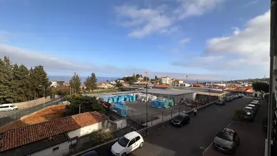 a street with cars parked in a parking lot at Edna 2 in Funchal