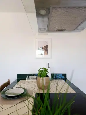 a dining room with a table with a potted plant at Novo! Jacuzzi, campo e praia in Vila do Bispo
