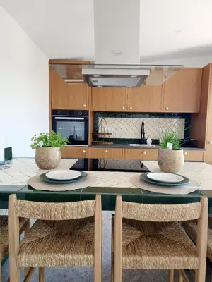 a kitchen with a table with two plates on it at Novo! Jacuzzi, campo e praia in Vila do Bispo