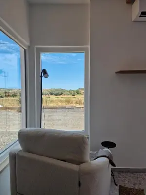 a living room with a couch and a window at Novo! Jacuzzi, campo e praia in Vila do Bispo