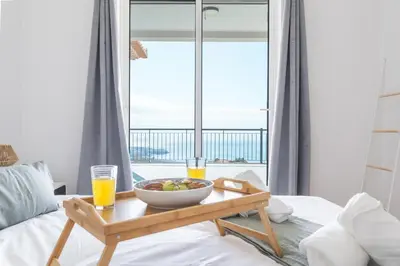 a table with a bowl of fruit on a bed with a window at Palm Paradise Villa by AH in Câmara de Lobos