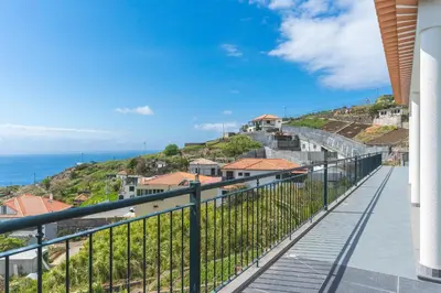 a balcony with a view of the ocean at Palm Paradise Villa by AH in Câmara de Lobos