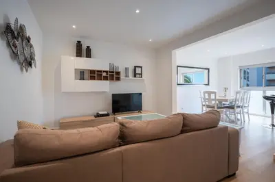 a living room with a brown couch and a table at Piornais Apartment by Holiday Rental Madeira in Funchal