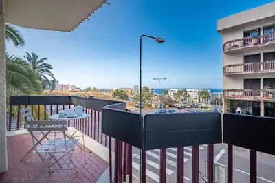 a balcony with a table and chairs and a view of a street at Piornais Apartment by Holiday Rental Madeira in Funchal